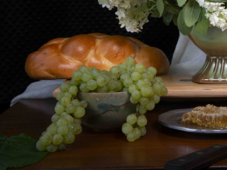 Golden braided bread with green grapes and natual honey